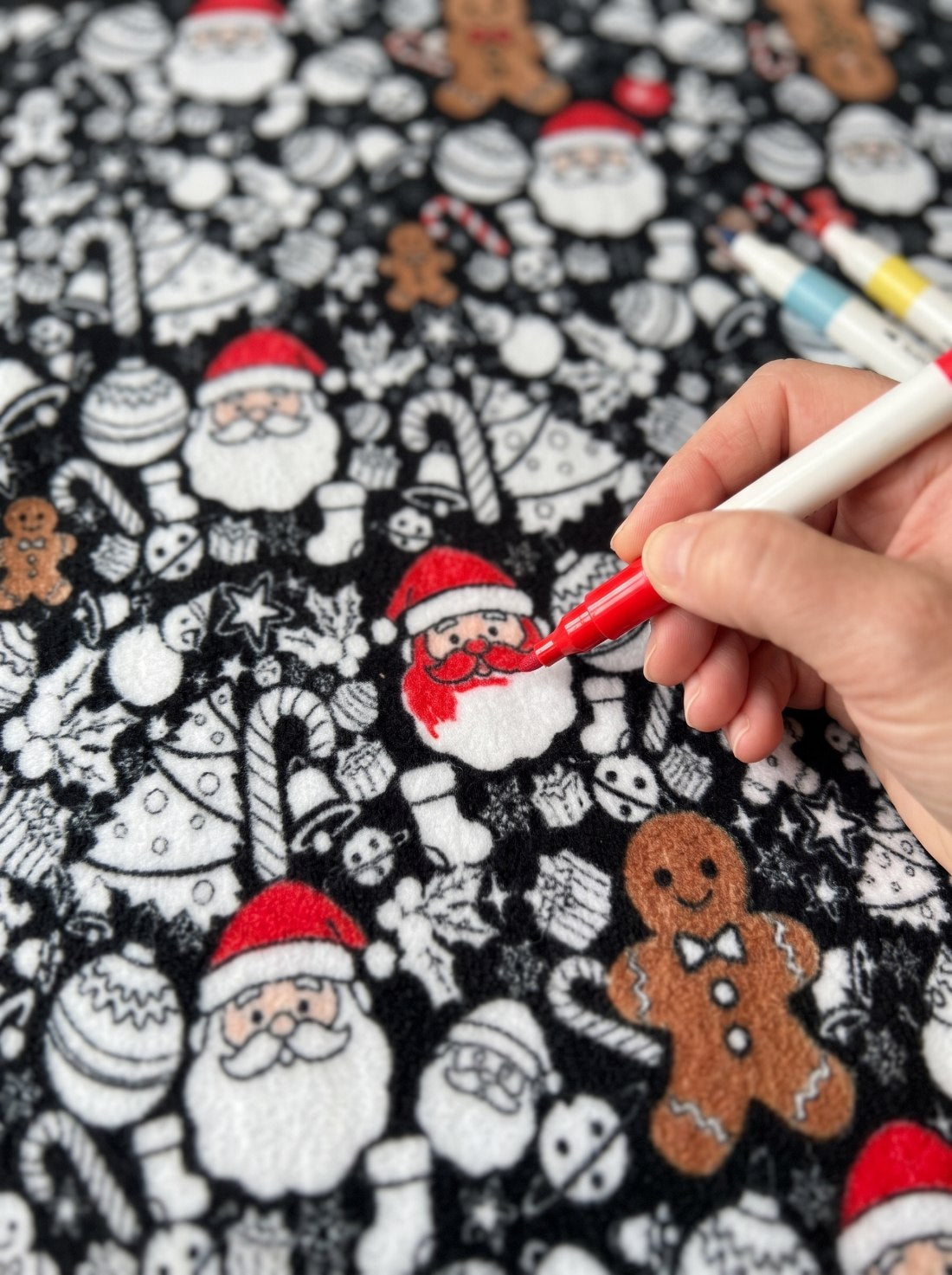 Coloring Santa and gingerbread on the fleece blanket with a fabric marker